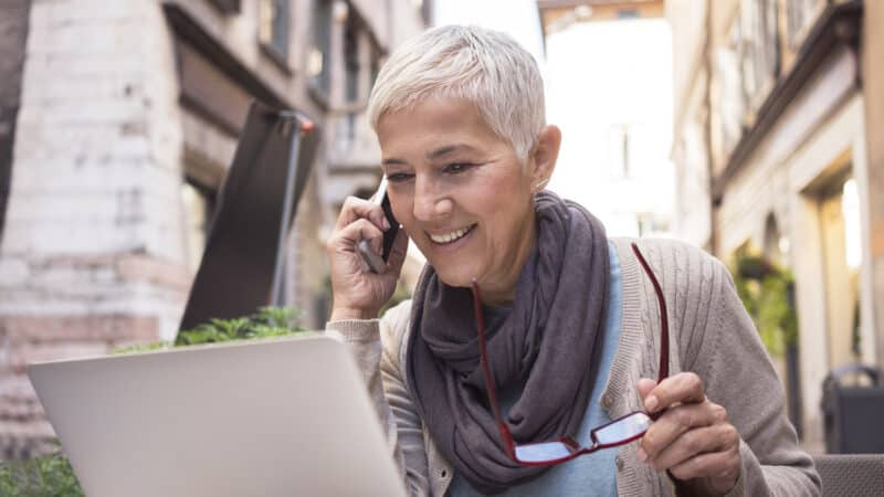 senior women working on a computer and talking on a phone