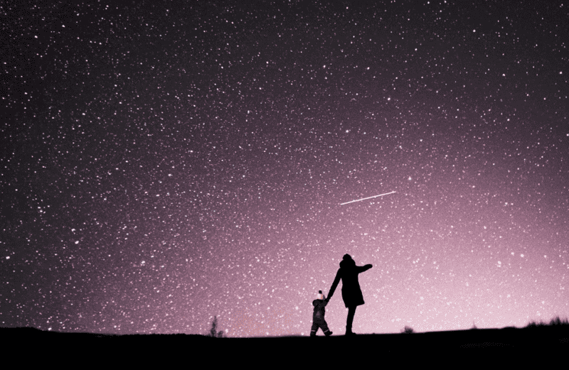 Mom and child looking at a starry night