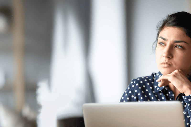 Woman working on a computer looking at the horizon